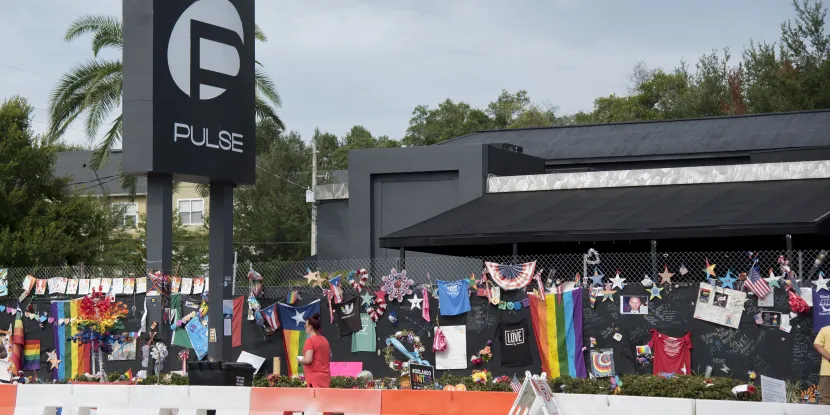 memorial with pride flags, photos, and testimonials honoring the victims of the Pulse nightclub shooting in Orlando