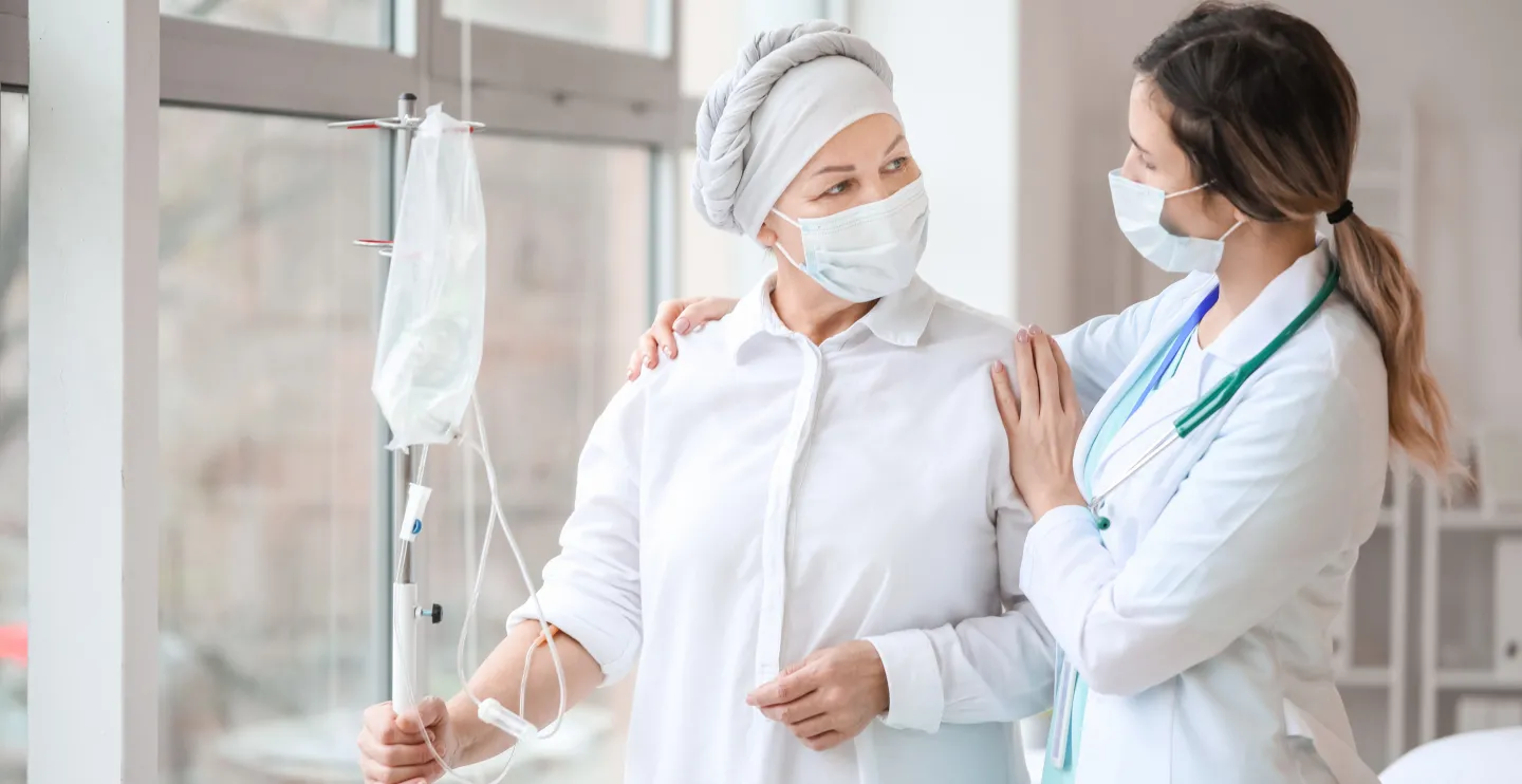 Doctor and woman undergoing chemical therapy course in clinic