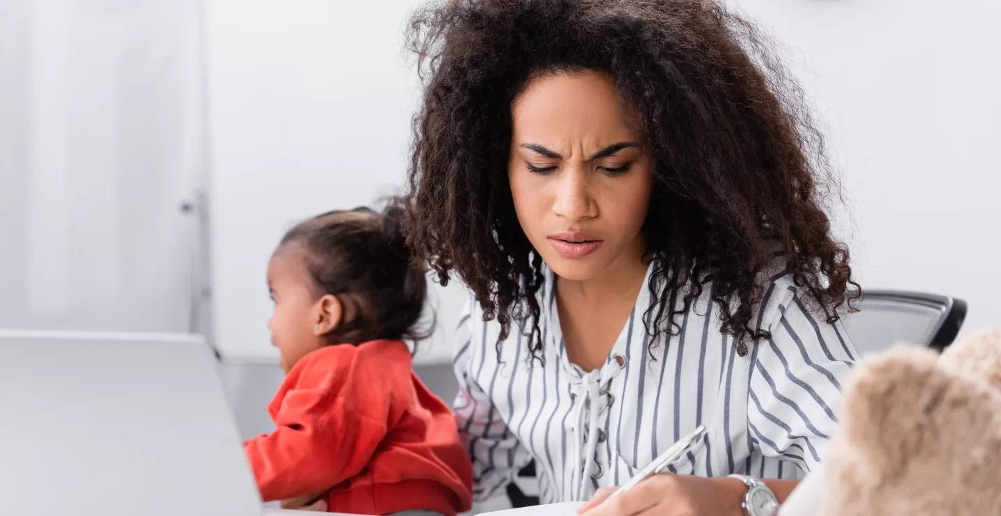 Young mom with toddler in front of laptop