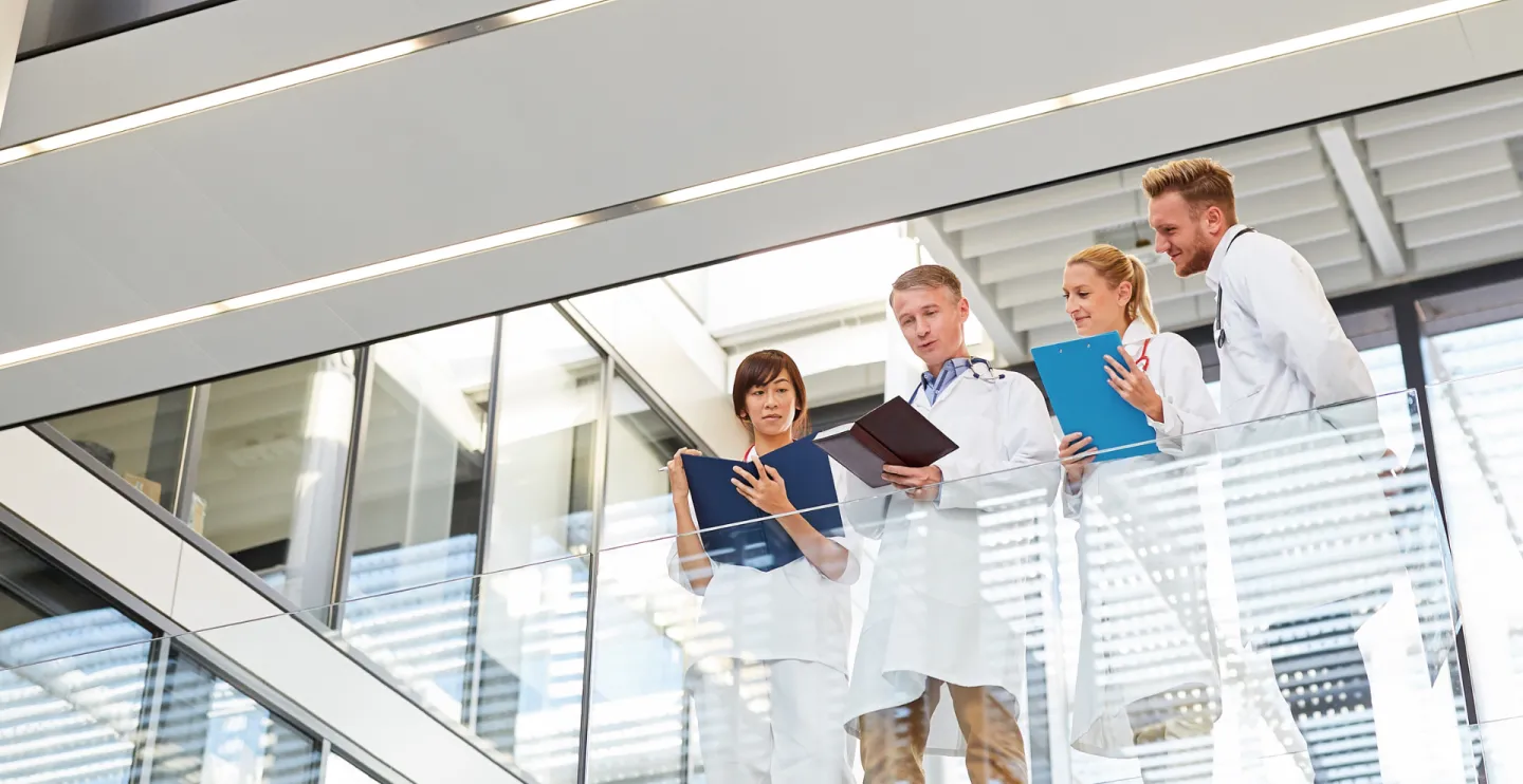 Group as a medical team in a meeting on the gallery in a hospital