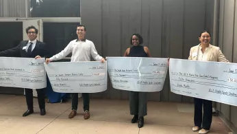 Four Health Equity Challenge winners Cameron Salehi, Nikolas Wianecki, Nadeeka Karunaratne, and Karla Murillo with their checks