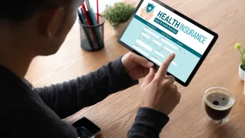 Person using an electronic tablet to sign up for health insurance